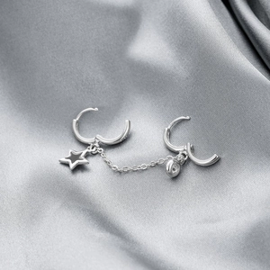 Star-shaped black enamel ear cuff set with silver chain and cubic zirconia stone