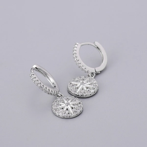 Macro shot of silver starburst hoop earrings with sparkling pavé cubic zirconia details