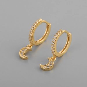 Detail of gold moon hoop earrings with sparkling cubic zirconia on a grey background