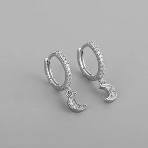 Close-up of S925 sterling silver earring with cubic zirconia crescent moon pendant detail