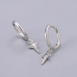 Macro view of S925 sterling silver stamp on minimalist star charm hoop earrings