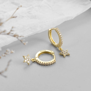 Macro detail of gold plated S925 sterling silver star hoop earrings with sparkling cubic zirconia