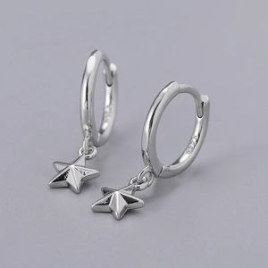 Macro detail of S925 sterling silver hoop earrings with star pendants and mirror polish