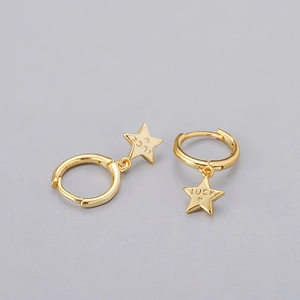 Detailed close-up of S925 sterling silver stamp and Luck engraving on gold star earrings