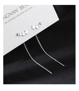 Detailed view of silver star earrings featuring crystal zircon stones and chain tassels