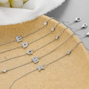 Detail of five silver bracelets with micro-paved zircon alphabet charms from A to E