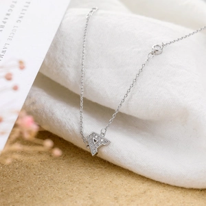 Macro detail of silver letter A pendant with shimmering micro-pave cubic zirconia stones
