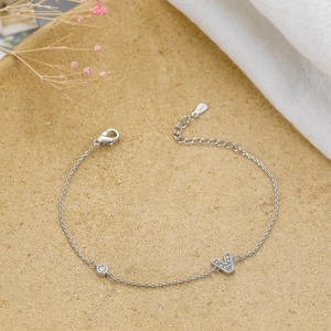 Detailed view of silver S925 bracelet with micro-pave zircon letter V pendant and lobster clasp