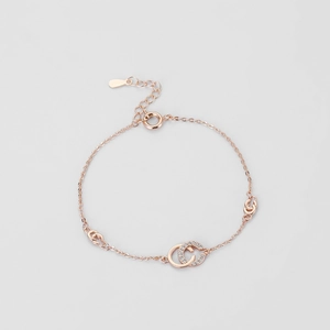 Macro shot of rose gold double C bracelet featuring micro-pave cubic zirconia settings