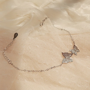 S925 sterling silver butterfly bracelet with shimmering cubic zirconia and lace background