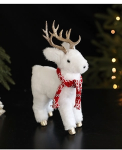 Close-up of a plush white Christmas reindeer with golden antlers and a red scarf