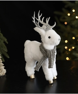 Detail of white plush reindeer ornament with silver antlers and a grey knitted scarf