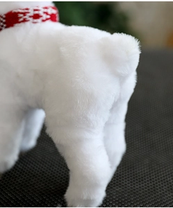 Detail of soft white plush reindeer fur texture with red knitted scarf ornament