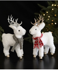 Close-up of white plush Christmas reindeer with glittery antlers and knit scarves