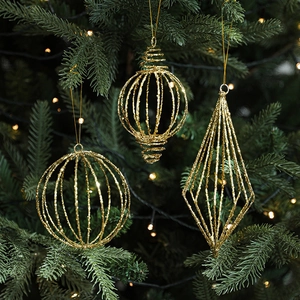 Golden glitter Christmas ball pendants set with geometric wire designs on a tree