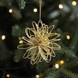 Sparkly gold wire glitter ball Christmas tree ornament with festive warm bokeh background
