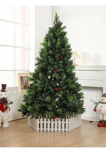 Close-up of white picket fence base surrounding a decorated Christmas tree with pine cones