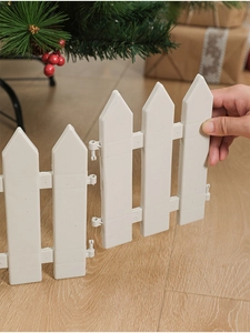 Detail of white plastic Christmas tree fence showing snap-lock assembly mechanism