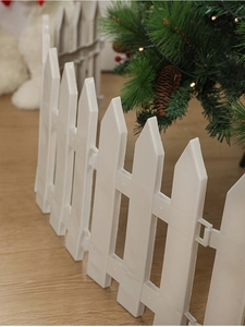 Close-up of white plastic picket fence panels for Christmas tree base decoration