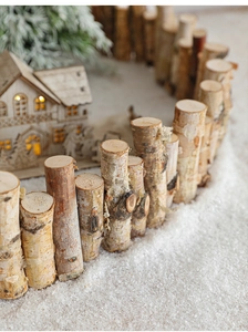 Close-up of natural birch wood Christmas fence with rustic bark texture for winter decor