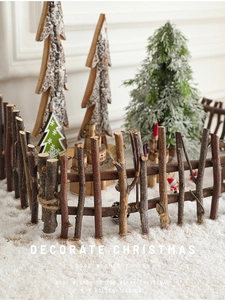 Macro detail of natural wood branch fence tied with hemp rope on snowy Christmas setting