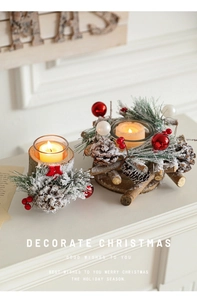 Detail of Christmas candle holder with pine cones and berries on white mantel