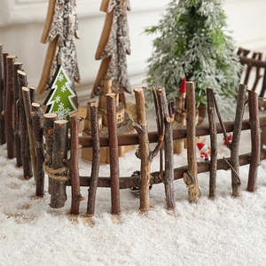 Handcrafted rustic natural wood branch Christmas tree fence with snowy festive background