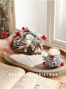 Rustic Christmas candle holder detail with pine cones, red berries, and glass cup