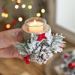 Rustic Christmas candle holder with natural pine cone, berries, and snow needles on wood