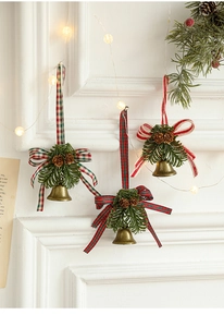 Close-up of vintage bronze metal bells with pine cones and festive ribbon bows