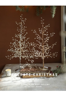 Detail of LED acrylic Christmas tree with pearl branches on a cozy desktop display