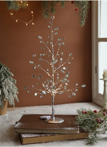 Macro shot of silver wire Christmas tree lamp with crystal beads and warm LED lights
