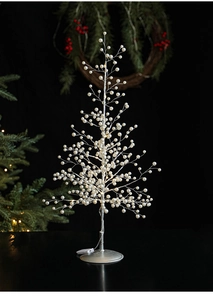 Macro view of LED desktop Christmas tree with silver wire and white pearl beads decoration
