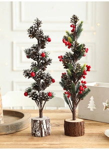 Detail of 40cm snowy artificial Christmas trees with pinecones, red berries and wood base