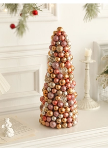 Macro view of a 35cm Christmas cone tree with gold and pink ornaments on a mantel