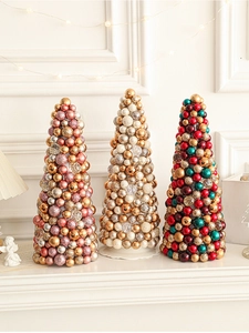 Three conical Christmas ball trees in pink, white, and red-green-gold holiday themes