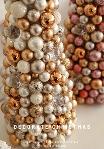 Close-up of a 35cm champagne gold Christmas tree tower with pearls and glitter baubles