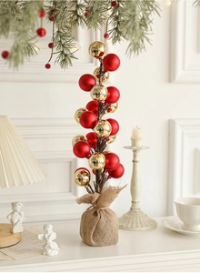 Macro detail of the creative Christmas tree base wrapped in rustic burlap sack with red balls