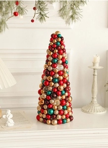Close-up of a 35cm Christmas ball cone tree decoration on a white festive mantelpiece