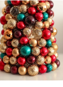 Detail of Christmas tree tower with colorful red gold and green ornaments in varied textures