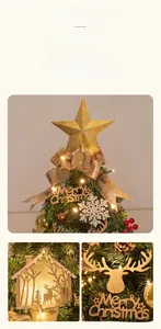 Detail of luxury Christmas tree set with gold star topper, ribbons and LED lights