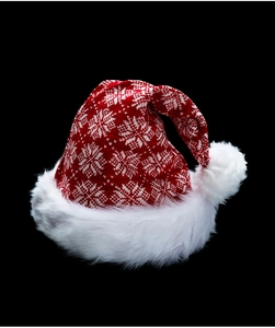 Close-up of red knitted Christmas hat with snowflake patterns and white faux fur trim