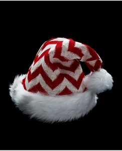 Detailed view of red and white knit Christmas hat with soft plush trim and pom-pom