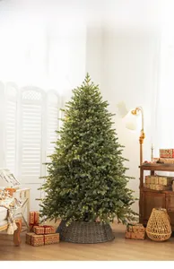 Detail of luxury dual-color PE Christmas tree with warm LED lights and woven base