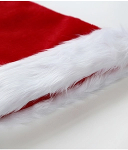 Close-up of soft red fabric and fluffy white faux fur trim on a Christmas hat