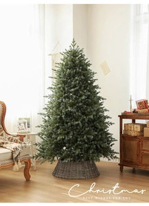Close-up of luxury PE Christmas tree with dense needles and woven brown tree skirt