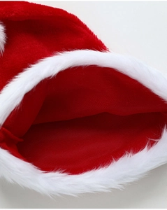 Detail of red plush fabric and white fluffy fur trim on the Christmas hat opening