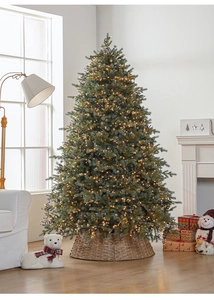 Close-up of dense green Christmas tree branches with warm micro LED lights and rattan tree base