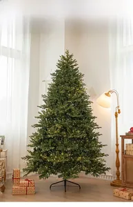 Close-up of dense mixed needle branches with warm yellow LED lights on a luxury Christmas tree