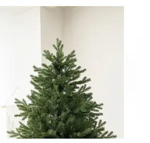 Close-up of dense artificial Christmas tree branches with realistic green pine needles